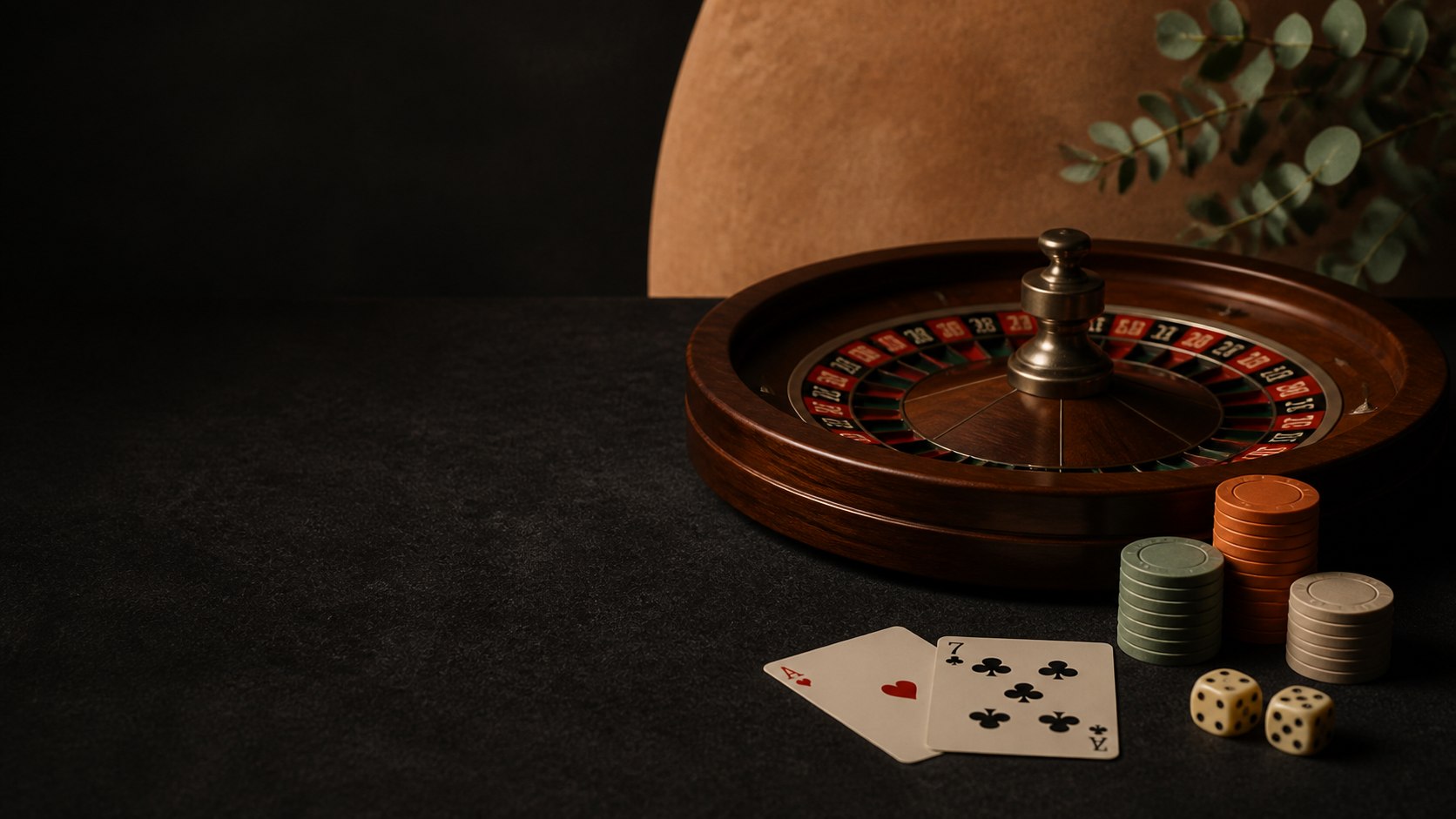 Roulette wheel, cards, dice and unbranded chips arranged on a dark table
